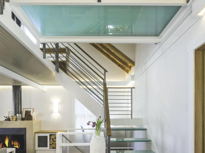 View from ground floors and new hardwood floors leading to custom stairs