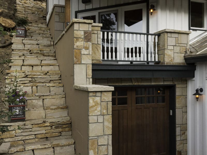 Exterior of a home with custom stone steps and small car port
