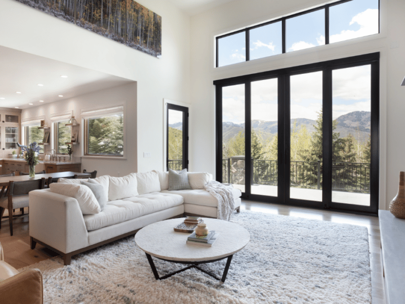 Large windows in a living room with a view of the mountains