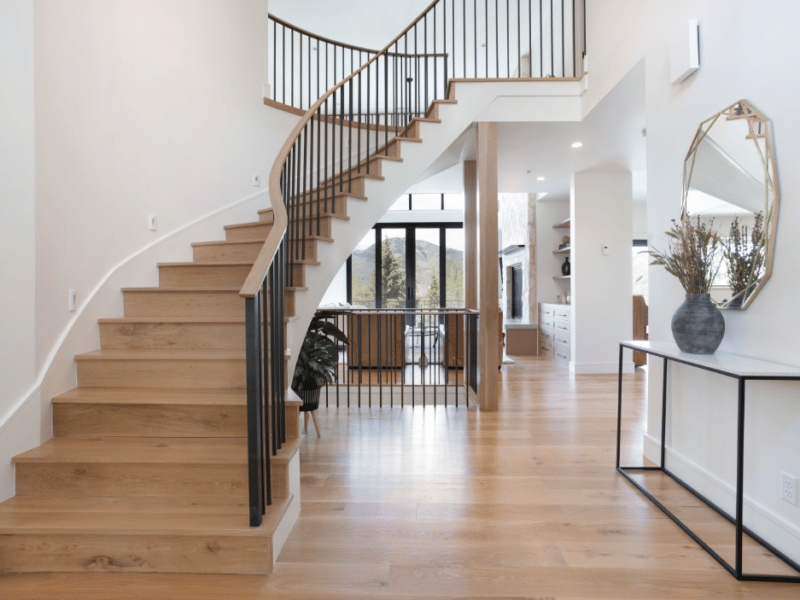 Hardwood floors and hardwood stairs in a white home