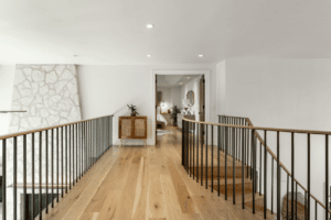 Hardwood flooring at the top of a staircase leading into master bedroom