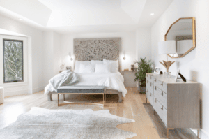 Master bedroom with a white bed and grey rug