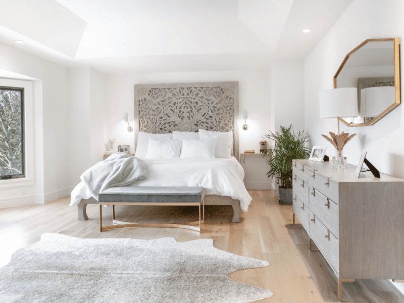 Master bedroom with a white bed and grey rug