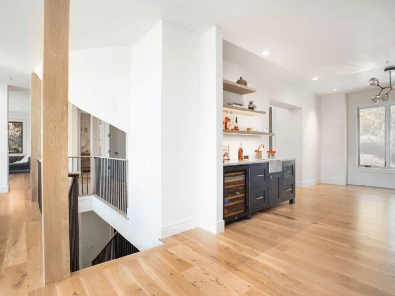 Hardwood floors at the top of a staircase leading into game room