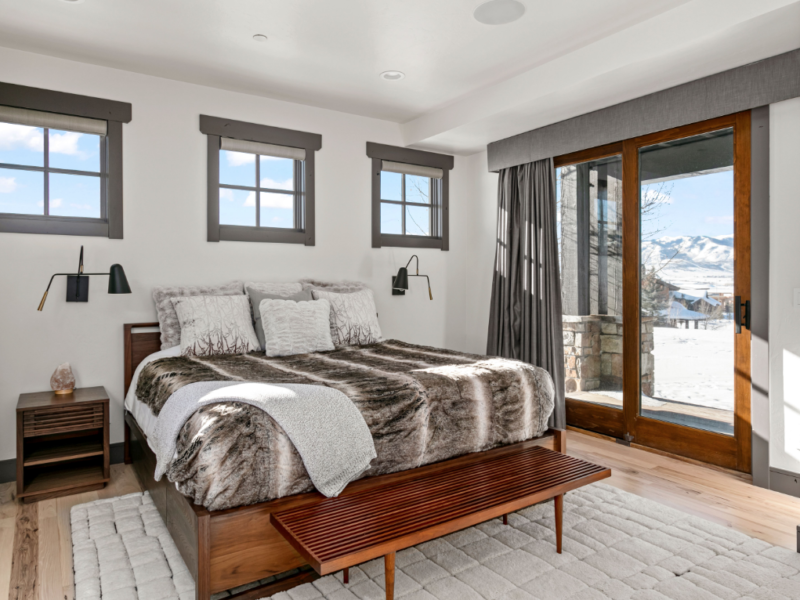 Bedroom with side door leading to backyard