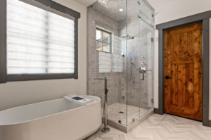 Standing shower next to a custom built bathtub