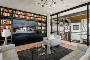 Home's library with tv in the wall with side view of entryway