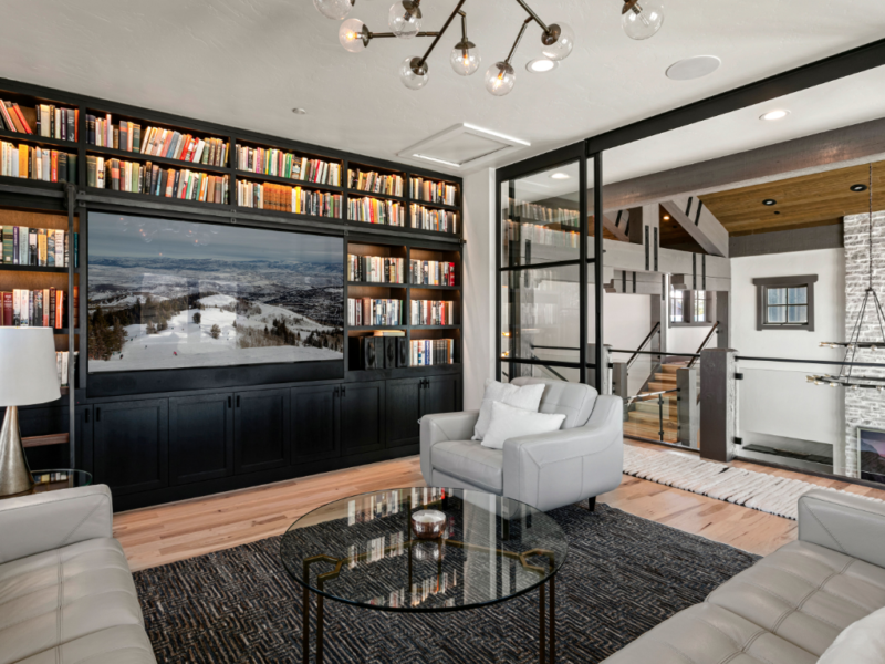 Home's library with tv in the wall with side view of entryway