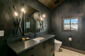 Custom bathroom with black walls and countertops