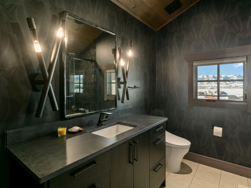 Custom bathroom with black walls and countertops