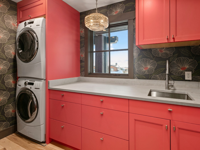 Laundry room with red cabinets and shelving