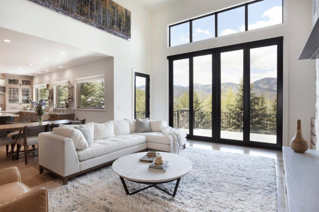 Large windows in a living room with a view of the mountains