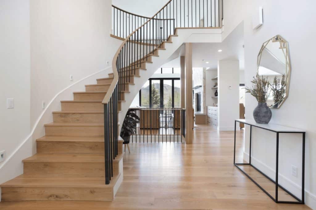 Hardwood floors and hardwood stairs in a white home