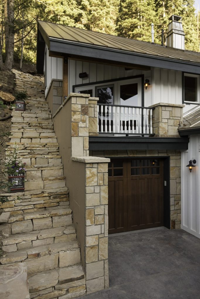 Exterior of a home with custom stone steps and small car port