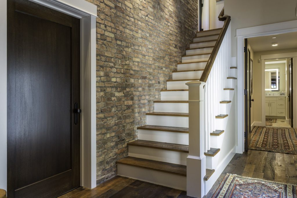 Hallway with hardwood floors and custom hardwood stairs