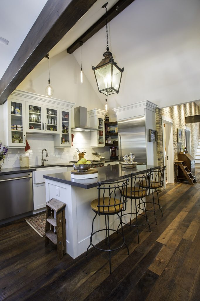 Kitchen with island bar and hardwood floors