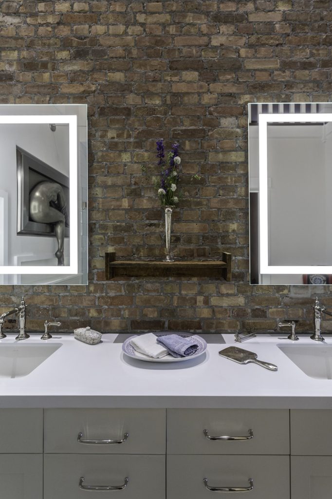 Southern Charm-Master Bathroom with double sinks and custom brick wall